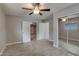 Bedroom featuring tile floors, a ceiling fan, and a mirrored closet at 13235 W Ashwood Dr, Sun City West, AZ 85375