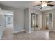 Bright bedroom featuring tile floors, a ceiling fan, and a mirrored closet at 13235 W Ashwood Dr, Sun City West, AZ 85375