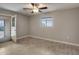 Well-lit bedroom features tile floors, a window and access to the outside at 13235 W Ashwood Dr, Sun City West, AZ 85375