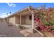 Exterior view of the covered patio with desert landscaping including flowers and rock ground cover at 13235 W Ashwood Dr, Sun City West, AZ 85375