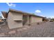 Home exterior featuring covered entryway and low-maintenance desert landscaping with stone accents at 13235 W Ashwood Dr, Sun City West, AZ 85375