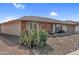 This landscaped front yard showcases desert plants and a charming single story home with brick accents at 13235 W Ashwood Dr, Sun City West, AZ 85375