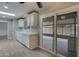 Bright kitchen featuring white cabinets, a skylight, and a sliding glass door at 13235 W Ashwood Dr, Sun City West, AZ 85375