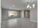 Living room boasts tile floors, recessed lighting, and a bright window overlooking the front yard at 13235 W Ashwood Dr, Sun City West, AZ 85375