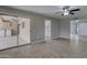 Bright living room featuring wood-look tile floors and a ceiling fan with seamless access to the kitchen at 13235 W Ashwood Dr, Sun City West, AZ 85375