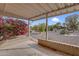 Covered patio surrounded by beautiful desert landscaping with plants, trees and flowering bushes at 13235 W Ashwood Dr, Sun City West, AZ 85375