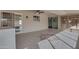 Spacious sunroom featuring neutral tile flooring, ceiling fan and sliding glass doors to the exterior at 13235 W Ashwood Dr, Sun City West, AZ 85375