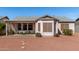 A view of the back of the home, which features a covered patio and easy-care desert landscaping at 1339 E Silverbrush Trl, Casa Grande, AZ 85122