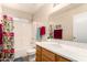 Bright bathroom featuring a combination shower-tub and vanity at 1339 E Silverbrush Trl, Casa Grande, AZ 85122