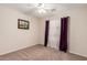 Cozy bedroom with carpeted floors, ceiling fan, and natural light at 1339 E Silverbrush Trl, Casa Grande, AZ 85122