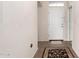 Inviting foyer with neutral walls, tiled floor, a decorative rug and a white front door at 1339 E Silverbrush Trl, Casa Grande, AZ 85122