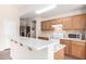 Well-lit kitchen with updated countertops, wood cabinets, a breakfast bar and stainless steel appliances at 1339 E Silverbrush Trl, Casa Grande, AZ 85122