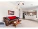 Open concept living room showcasing a comfortable sofa, neutral walls, and a view into the kitchen area at 1339 E Silverbrush Trl, Casa Grande, AZ 85122