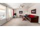 Bright living room featuring neutral walls, carpet, a ceiling fan, large windows and comfortable furniture at 1339 E Silverbrush Trl, Casa Grande, AZ 85122