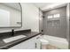 Stylized bathroom showcases sleek black hardware, a white vanity, and a tiled shower/tub combo at 1504 E Jasmine St, Mesa, AZ 85203