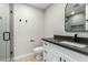 Modern bathroom featuring a white vanity with dark countertop and a glass-enclosed shower at 1504 E Jasmine St, Mesa, AZ 85203