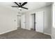 Neutral bedroom includes carpet, ceiling fan, closet, and connects to other rooms at 1504 E Jasmine St, Mesa, AZ 85203