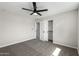 Spacious bedroom with neutral walls, ceiling fan, closet, and ensuite bathroom access at 1504 E Jasmine St, Mesa, AZ 85203