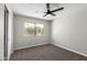 Bright bedroom with soft carpet, ceiling fan, and sunlit window offering a pleasant view at 1504 E Jasmine St, Mesa, AZ 85203