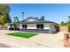 Single-story home with a well-kept yard and a stylish black and white exterior at 1504 E Jasmine St, Mesa, AZ 85203