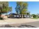 Lovely home with an attached two car garage, stylish black and white exterior, and gravel landscaping at 1504 E Jasmine St, Mesa, AZ 85203