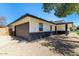 Attached two-car garage with a stylish dark gray door and a black and white color scheme at 1504 E Jasmine St, Mesa, AZ 85203