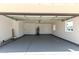 Open view of painted garage with epoxy flooring, water heater, and natural light at 1504 E Jasmine St, Mesa, AZ 85203