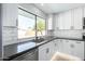 Bright kitchen featuring stone countertops and white cabinetry at 1504 E Jasmine St, Mesa, AZ 85203