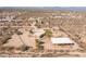 Aerial view of a desert property with a house, garage, and horse pen at 16835 E Skinner Dr, Rio Verde, AZ 85263