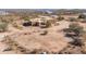 Aerial shot showcases a sprawling desert property with custom home and fencing at 16835 E Skinner Dr, Rio Verde, AZ 85263