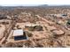 Aerial view of a desert property featuring the house, a horse pen, and a garage at 16835 E Skinner Dr, Rio Verde, AZ 85263