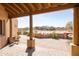 Covered back patio with brick pavers, desert views, and mature plants at 16835 E Skinner Dr, Rio Verde, AZ 85263