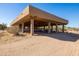 Spacious covered barn area with beams, posts, and adjacent desert landscape at 16835 E Skinner Dr, Rio Verde, AZ 85263