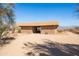 Picturesque barn structure featuring a drive through and stone accents in a desert landscape at 16835 E Skinner Dr, Rio Verde, AZ 85263