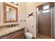 Well-lit bathroom featuring granite countertops, a unique mirror, and a glass-enclosed shower at 16835 E Skinner Dr, Rio Verde, AZ 85263