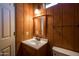 Cozy bathroom featuring wood paneled walls, vanity with mirror, and a toilet at 16835 E Skinner Dr, Rio Verde, AZ 85263