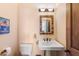 Powder room featuring pedestal sink, craftsman style mirror, and classic fixtures at 16835 E Skinner Dr, Rio Verde, AZ 85263