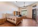 Cozy bedroom with neutral walls, a decorative bed frame, tile floors, and a ceiling fan, offering a relaxing retreat at 16835 E Skinner Dr, Rio Verde, AZ 85263