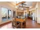 Bright dining area adjacent to the kitchen, featuring a wooden table, tile floors, and large windows with views at 16835 E Skinner Dr, Rio Verde, AZ 85263