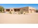 Desert home boasts covered porches, a front courtyard, and a circular driveway at 16835 E Skinner Dr, Rio Verde, AZ 85263