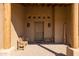 Covered front entryway with bench seating, brick pavers, and wood beam columns at 16835 E Skinner Dr, Rio Verde, AZ 85263