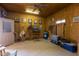 Rustic garage boasts wood paneled walls, concrete floors, and a ceiling fan to circulate air at 16835 E Skinner Dr, Rio Verde, AZ 85263