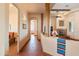 Hallway with wood beam columns leads to living area with stone fireplace and interior views at 16835 E Skinner Dr, Rio Verde, AZ 85263