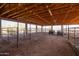 Spacious barn with stalls, a dirt floor, and beamed ceilings, providing ample space for horses or other animals at 16835 E Skinner Dr, Rio Verde, AZ 85263