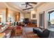 Large living room featuring wood beam ceilings, a cozy fireplace, and desert views at 16835 E Skinner Dr, Rio Verde, AZ 85263