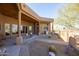 Covered patio featuring decorative cacti and landscaping, offering the perfect outdoor space for relaxation and entertainment at 16835 E Skinner Dr, Rio Verde, AZ 85263