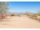 Gated property featuring desert landscape, native plants, and mountain views on a sunny day at 16835 E Skinner Dr, Rio Verde, AZ 85263