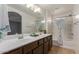 Bathroom with double sinks, white countertops, and shower and tub combination with tile flooring at 1950 N Center St # 111, Mesa, AZ 85201