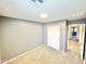 Empty bedroom features neutral carpet, closet, and light grey walls at 1950 N Center St # 111, Mesa, AZ 85201