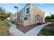 Exterior view of a townhome complex featuring stucco walls, manicured landscaping, and well-lit sidewalks at 1950 N Center St # 111, Mesa, AZ 85201